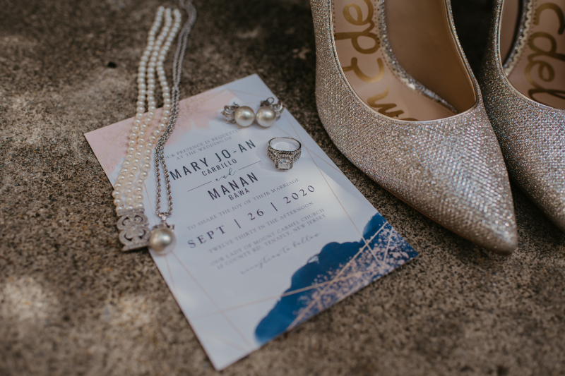 Classic wedding invitations, shoes, jewelry flatlay
