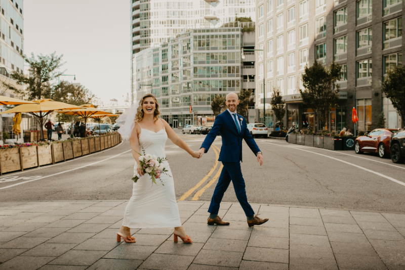 Bride and groom crossing the street